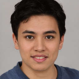 Joyful asian young-adult male with short  brown hair and brown eyes