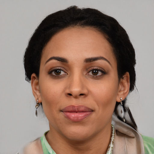 Joyful latino young-adult female with short  brown hair and brown eyes