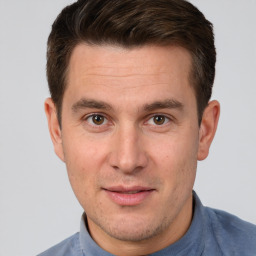 Joyful white young-adult male with short  brown hair and brown eyes