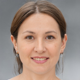 Joyful white adult female with medium  brown hair and brown eyes