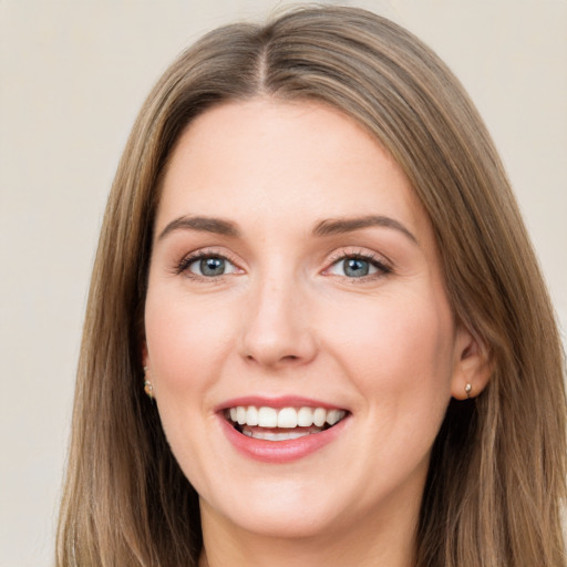 Joyful white young-adult female with long  brown hair and green eyes