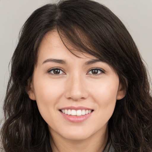 Joyful white young-adult female with long  brown hair and brown eyes