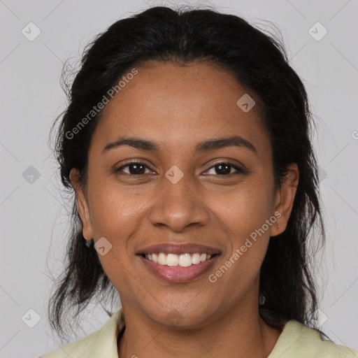 Joyful latino adult female with medium  brown hair and brown eyes