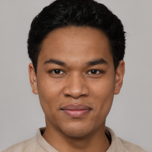 Joyful latino young-adult male with short  black hair and brown eyes