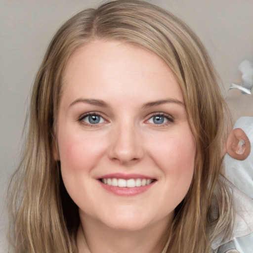 Joyful white young-adult female with medium  brown hair and blue eyes