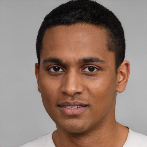 Joyful black young-adult male with short  black hair and brown eyes