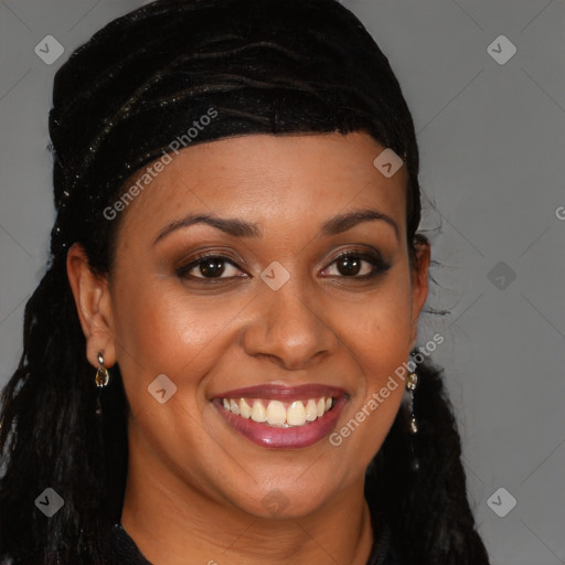 Joyful black young-adult female with long  brown hair and brown eyes