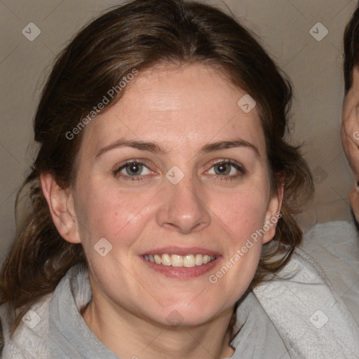 Joyful white adult female with medium  brown hair and blue eyes