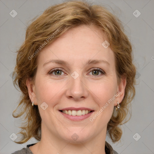 Joyful white adult female with medium  brown hair and blue eyes