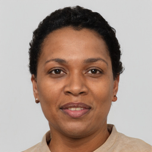 Joyful black adult female with short  black hair and brown eyes