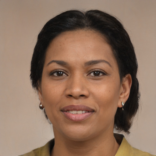 Joyful black young-adult female with medium  brown hair and brown eyes