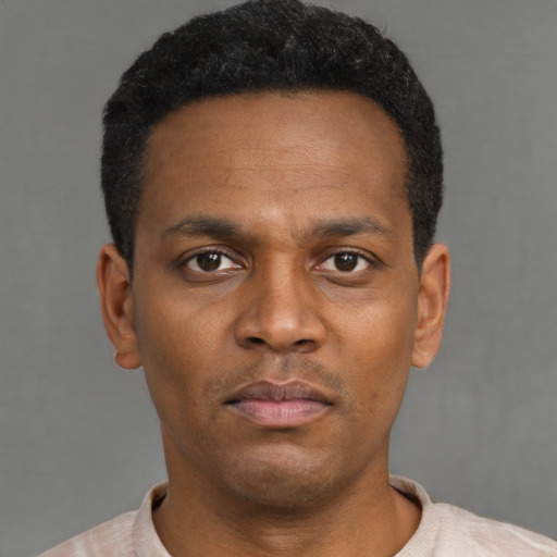 Neutral black young-adult male with short  black hair and brown eyes