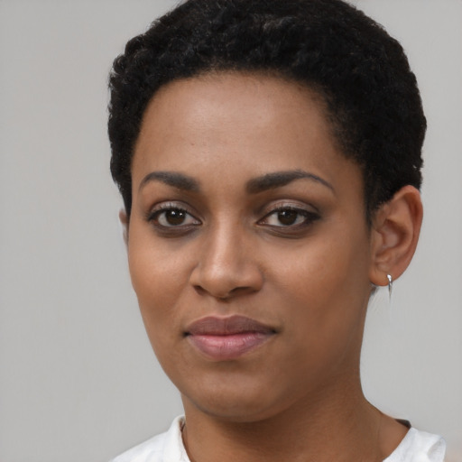 Joyful black young-adult female with short  black hair and brown eyes