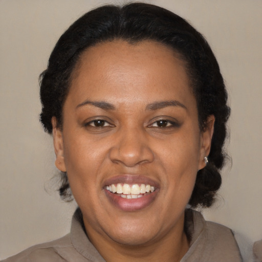 Joyful black adult female with medium  black hair and brown eyes