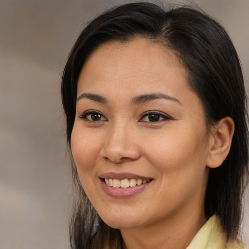 Joyful asian young-adult female with medium  brown hair and brown eyes