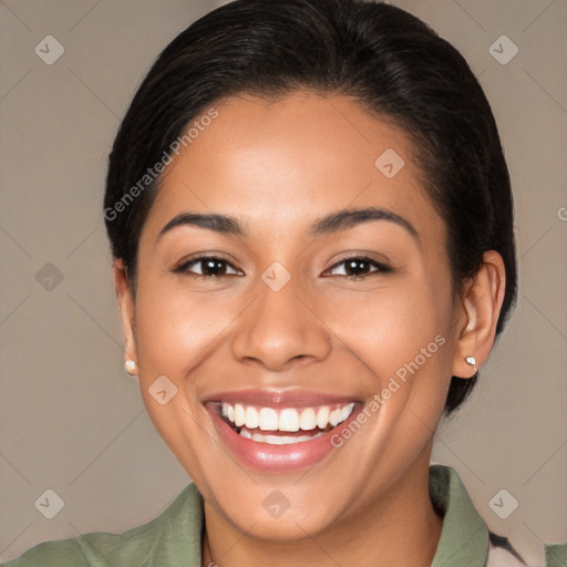 Joyful latino young-adult female with medium  brown hair and brown eyes