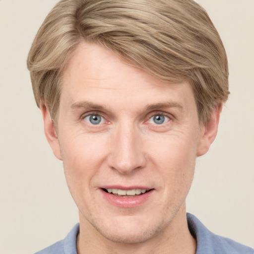 Joyful white adult male with short  brown hair and grey eyes