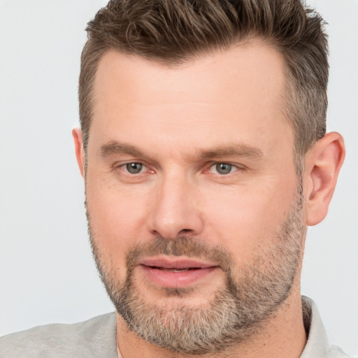 Joyful white adult male with short  brown hair and brown eyes