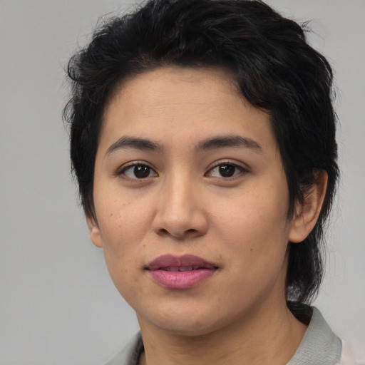 Joyful latino young-adult female with medium  black hair and brown eyes