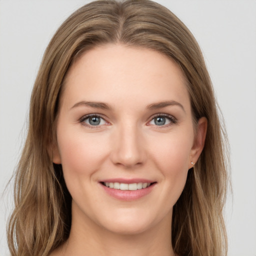 Joyful white young-adult female with long  brown hair and grey eyes