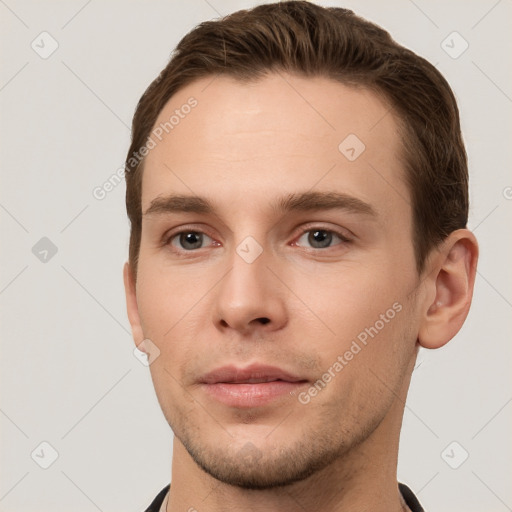 Joyful white young-adult male with short  brown hair and grey eyes