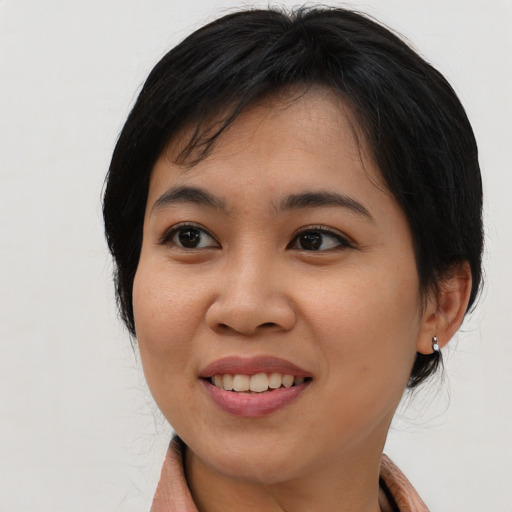 Joyful asian young-adult female with medium  black hair and brown eyes