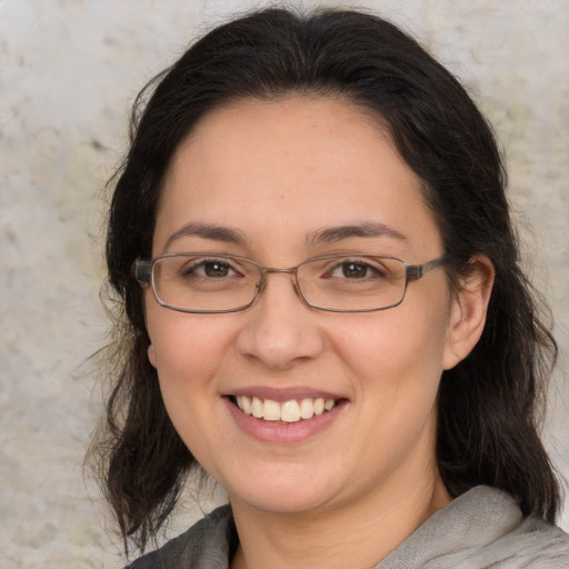 Joyful white adult female with medium  brown hair and brown eyes