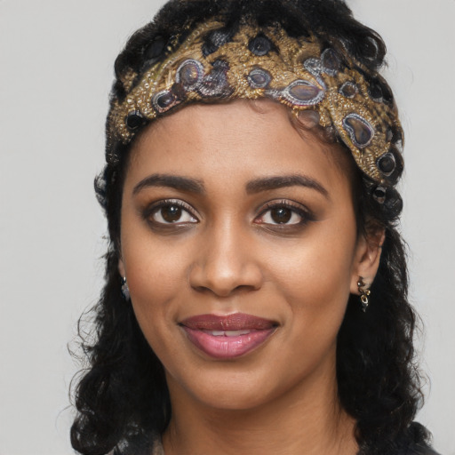Joyful black young-adult female with long  black hair and brown eyes
