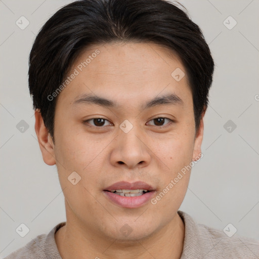 Joyful asian young-adult male with short  brown hair and brown eyes