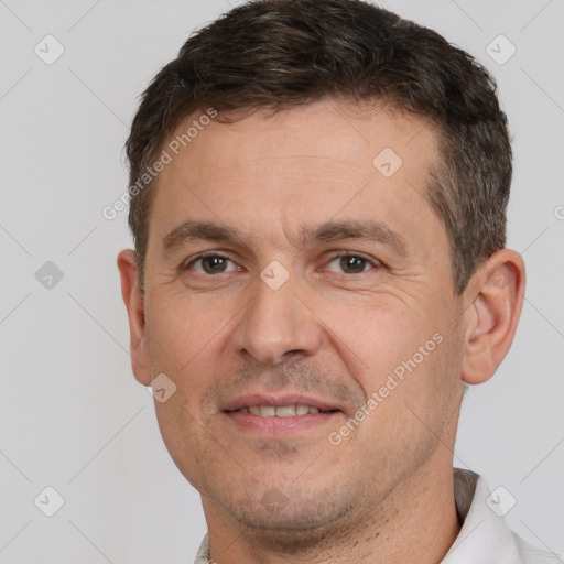 Joyful white adult male with short  brown hair and brown eyes