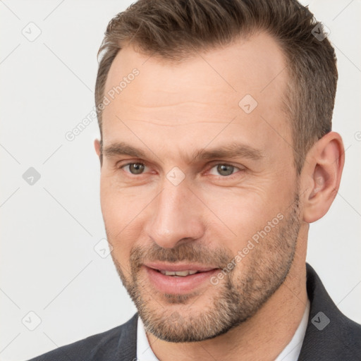 Joyful white adult male with short  brown hair and brown eyes