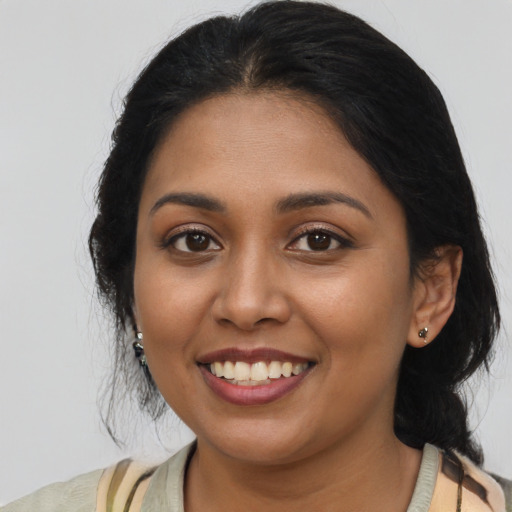 Joyful latino young-adult female with medium  black hair and brown eyes