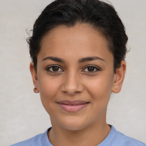 Joyful latino young-adult female with short  brown hair and brown eyes