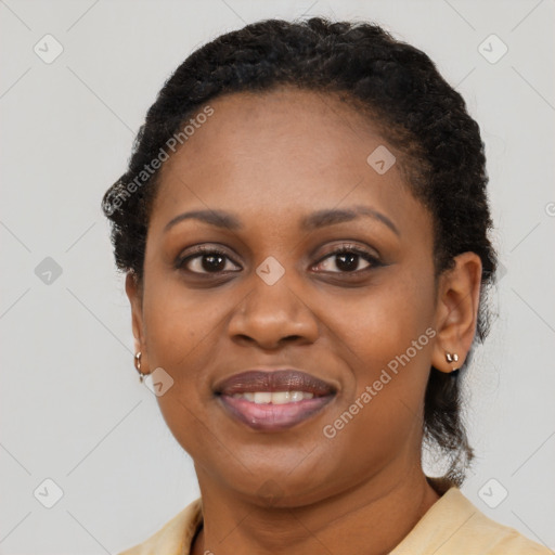 Joyful black young-adult female with short  brown hair and brown eyes