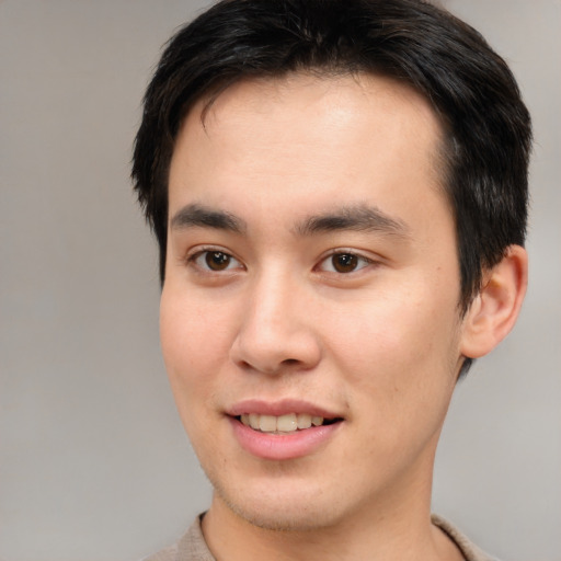 Joyful asian young-adult male with short  brown hair and brown eyes