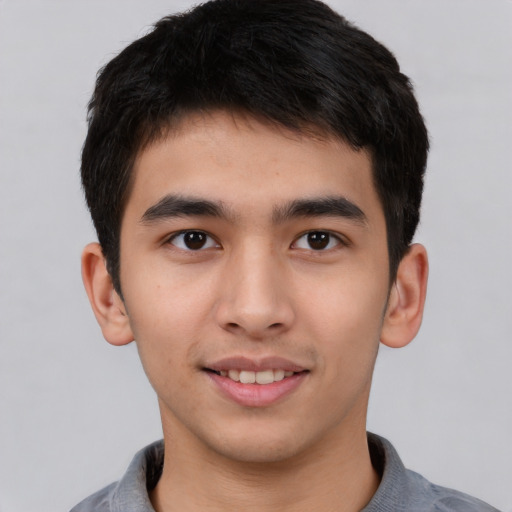 Joyful asian young-adult male with short  black hair and brown eyes