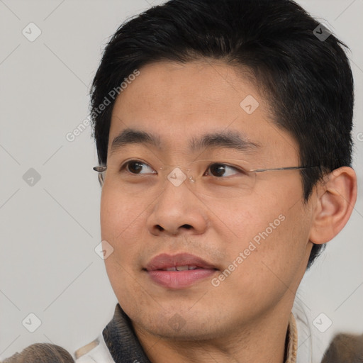 Joyful asian young-adult male with short  brown hair and brown eyes