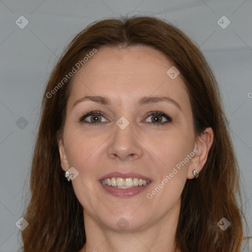 Joyful white adult female with long  brown hair and brown eyes