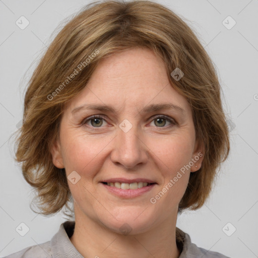 Joyful white adult female with medium  brown hair and grey eyes