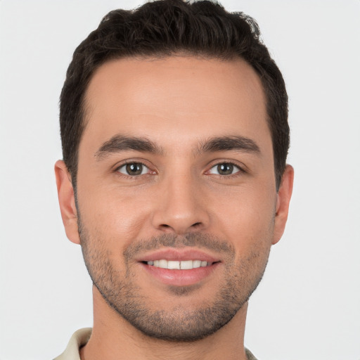 Joyful white young-adult male with short  brown hair and brown eyes