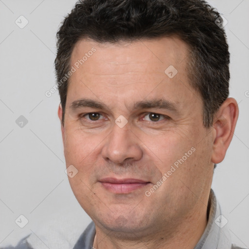 Joyful white adult male with short  brown hair and brown eyes