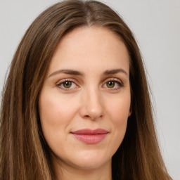 Joyful white young-adult female with long  brown hair and green eyes