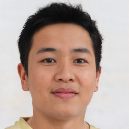 Joyful asian young-adult male with short  brown hair and brown eyes