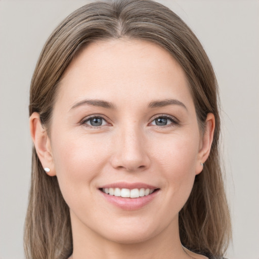 Joyful white young-adult female with long  brown hair and grey eyes