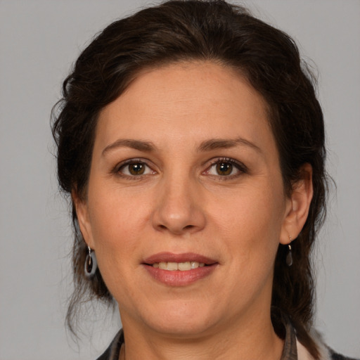 Joyful white adult female with medium  brown hair and brown eyes