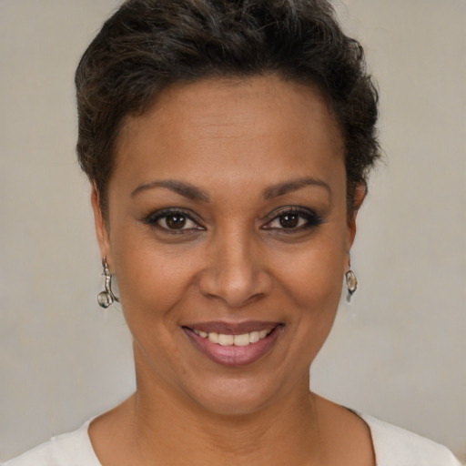 Joyful black young-adult female with short  brown hair and brown eyes