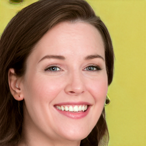 Joyful white young-adult female with long  brown hair and green eyes