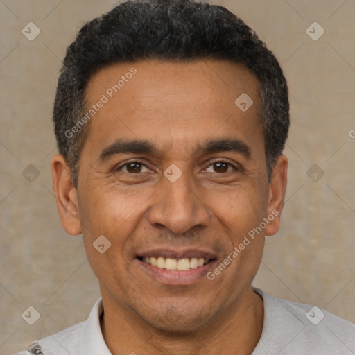 Joyful latino adult male with short  black hair and brown eyes