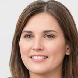 Joyful white young-adult female with long  brown hair and grey eyes