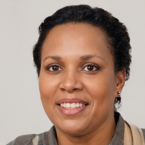 Joyful latino adult female with short  brown hair and brown eyes